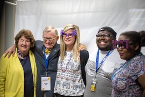Campus President Carolyn Long and WVU President Gordon Gee pose with students at a photo booth.