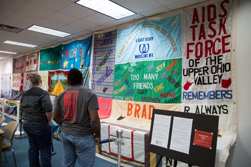 WVU Tech students view three pieces of the NAMES Project Memorial AIDS Quilt in the library.