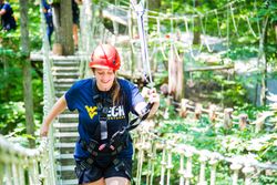 WVU Tech student Jessica Beck crosses a rope bridge during Tech Adventures.