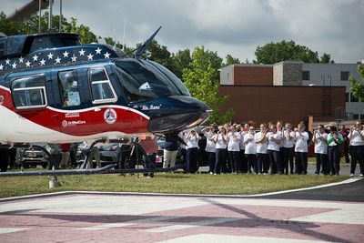 Students watch the air evac helicopter take off with their mock patient.