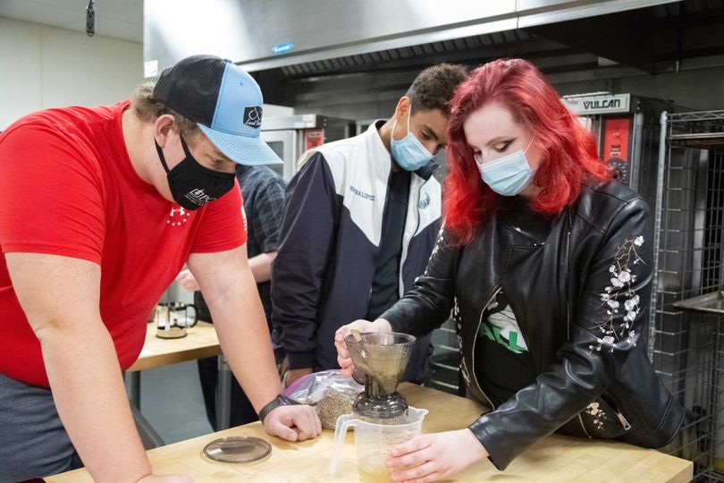 Students work together to brew coffee