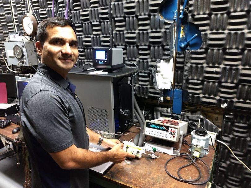 Dr. Yogendra Panta displays a prototype device in a laboratory at the NASA Glenn Research Center in Cleveland, Ohio.