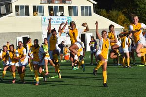 Women's soccer celebrates a Homecoming win.